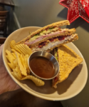 Three slices of golden toast stacked with roast turkey, honey roast ham, sage & onion stuffing, cheese,